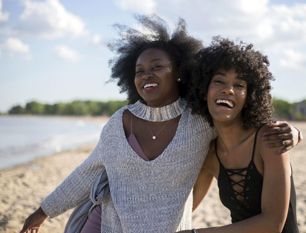friends-laughing-on-beach-2100x1596