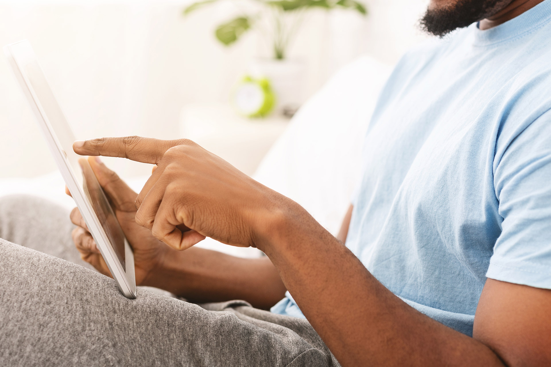 man-searching-for-local-dentist-on-tablet A man at home searching for a local dentist on his tablet