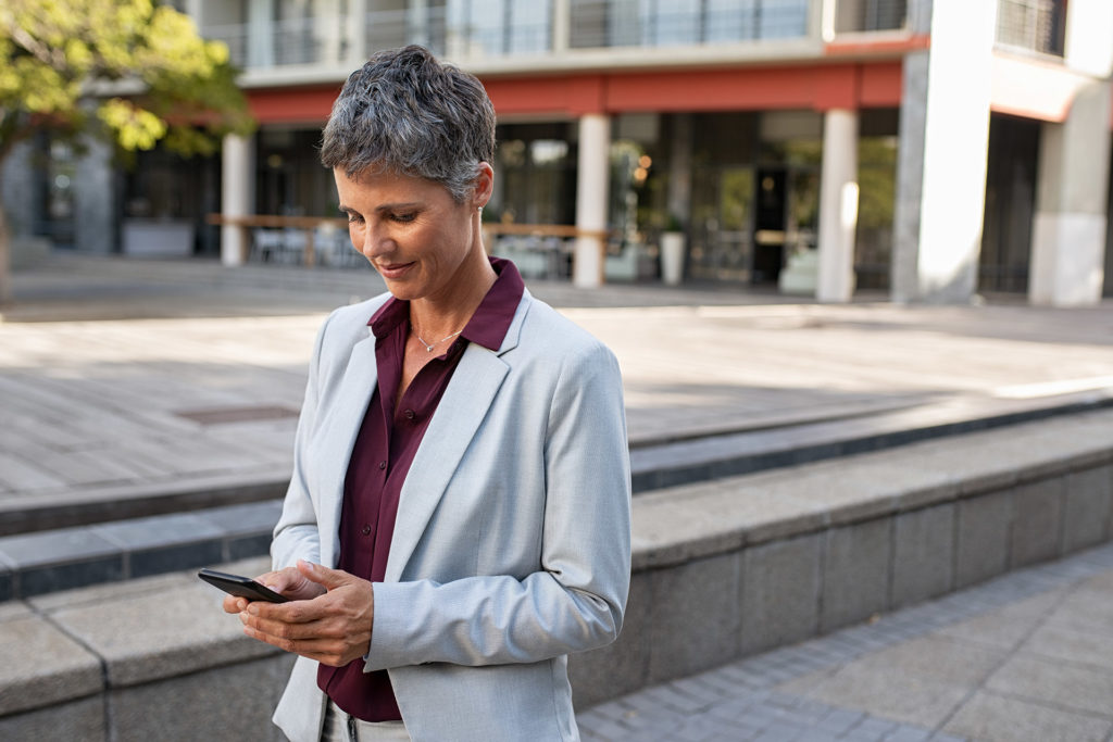 Businesswoman finds a local dentist easily thanks to the practice's local SEO from geo-targeted landing pages